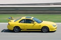 Japanese yellow Honda Prelude car skidding on a circuit