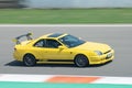 Japanese yellow Honda Prelude car skidding on a circuit