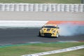 Japanese yellow Nissan 350Z car skidding on a circuit