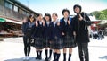 Japanese young schoolgirls posing with tourists Royalty Free Stock Photo