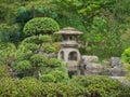 Japanese Zen garden with Bonsai and traditional stone lantern Royalty Free Stock Photo