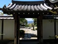 Japanese zen rock garden through the gate in Kyoto in summertime