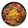 Japchae in black bowl isolated on white. Korean cuisine glass chapchae noodles dish with vegetables and meat