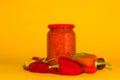 jar of ajvar in peppers on a yellow background, ajvar is a traditional Serbian specialty made from peppers and eggplant Royalty Free Stock Photo