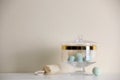 Jar with bath bombs and bath sponge on table against beige background Royalty Free Stock Photo