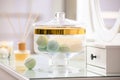 Jar with bath bombs and bath sponge on table indoors Royalty Free Stock Photo