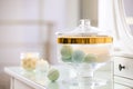 Jar with bath bombs and bath sponge on table Royalty Free Stock Photo