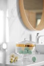 Jar with bath bombs and bath sponge on white countertop Royalty Free Stock Photo