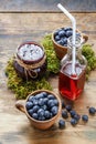 Jar of blueberry jam, bottle of juice and bowls of blueberries Royalty Free Stock Photo