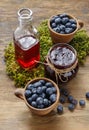 Jar of blueberry jam and bowls of blueberries Royalty Free Stock Photo