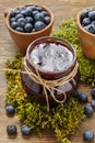 Jar of blueberry jam and bowls of blueberries Royalty Free Stock Photo