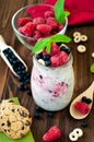 Jar with blueberry raspberry overnight oat on the rustic wooden