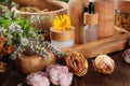 Jar, bottles of essential oils and different herbs on wooden table Royalty Free Stock Photo