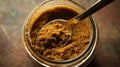 A jar of brown sugar with a spoon, showcasing its texture and culinary use Royalty Free Stock Photo