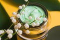 Jar of camomile face cream with camomile flowers with selective focus. Cosmetics pink background Royalty Free Stock Photo