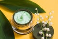 Jar of camomile face cream with camomile flowers with selective focus. Cosmetics pink background Royalty Free Stock Photo