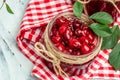 Jar of cherry jam and sour cherries. Berries cherry with syrup. Ripe ripe Sweet red cherries. Canned fruit on a light background Royalty Free Stock Photo