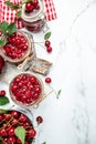 Jar of cherry jam and sour cherries. Berries cherry with syrup. Ripe ripe Sweet red cherries. Canned fruit on a light background Royalty Free Stock Photo