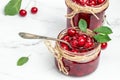 Jar of cherry jam and sour cherries. Berries cherry with syrup. Ripe ripe cherries. Sweet red cherries. Canned fruit on a wooden Royalty Free Stock Photo