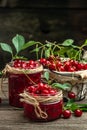 Jar of cherry jam and sour cherries. Berries cherry with syrup. Ripe ripe cherries. Sweet red cherries. Canned fruit on a wooden Royalty Free Stock Photo