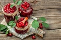 Jar of cherry jam and sour cherries. Berries cherry with syrup. Ripe ripe cherries. Sweet red cherries. Canned fruit on a wooden Royalty Free Stock Photo