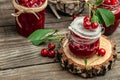 Jar of cherry jam and sour cherries. Berries cherry with syrup. Ripe ripe cherries. Sweet red cherries. Canned fruit on a wooden Royalty Free Stock Photo