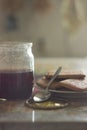 Jar of cherry-strawberry jam with cookies. Pleasant pastel colors, soft light. Morning still-life.