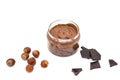 Jar of chocolate hazelnut spread, bunch of hazelnuts on white. Hazelnut butter, natural, organic product