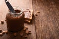 Jar of chocolate-nut paste spread and toast on a wooden background with copy space Royalty Free Stock Photo