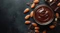 A jar of chocolate smoothie surrounded by almonds on a dark surface Royalty Free Stock Photo