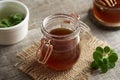 A jar of Coleus amboinicus syrup for common cold with fresh leaves