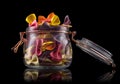 Jar of colorful farfalle pasta on wooden table isolated on black background