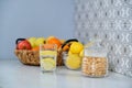 Jar of cornflakes, fruit basket, glass of sparkling water with lemon Royalty Free Stock Photo