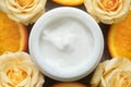 Jar of cream, roses and orange slices, closeup Royalty Free Stock Photo