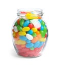 Jar of delicious color jelly beans on white Royalty Free Stock Photo