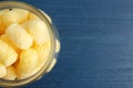 Jar of delicious crispy corn sticks on blue wooden table, top view. Space for text