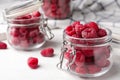 Jar of delicious fresh ripe raspberries on white wooden table, closeup view. Royalty Free Stock Photo