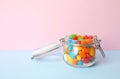 Jar of delicious jelly beans on color background Royalty Free Stock Photo