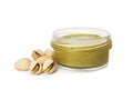 Jar with delicious pistachio butter and nuts on white background Royalty Free Stock Photo