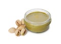 Jar with delicious pistachio butter and nuts on white background Royalty Free Stock Photo