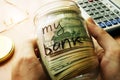 Jar with dollars and sign my bank. Home finances and savings concept. Royalty Free Stock Photo