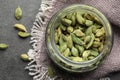 Jar with dry cardamom pods on dark grey table, top view Royalty Free Stock Photo