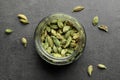 Jar with dry cardamom pods on dark grey table, top view Royalty Free Stock Photo