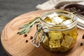 Jar with feta cheese marinated in oil. Pickled food Royalty Free Stock Photo