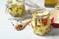 Jar with feta cheese marinated in oil on white wooden table Royalty Free Stock Photo