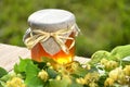 Jar of fresh and delicious honey with linden flowers