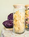 Jar full of pasta and red cabbage on the side on a decorated table cover Royalty Free Stock Photo