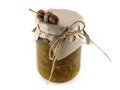 Jar of gooseberry jam decorated in Kraft paper. Useful jam made from gooseberries. Acorns and jam jar on white background