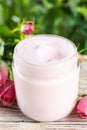 Jar of hand cream and roses on white wooden table, closeup Royalty Free Stock Photo