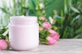 Jar of hand cream and roses on white wooden table, space for text Royalty Free Stock Photo